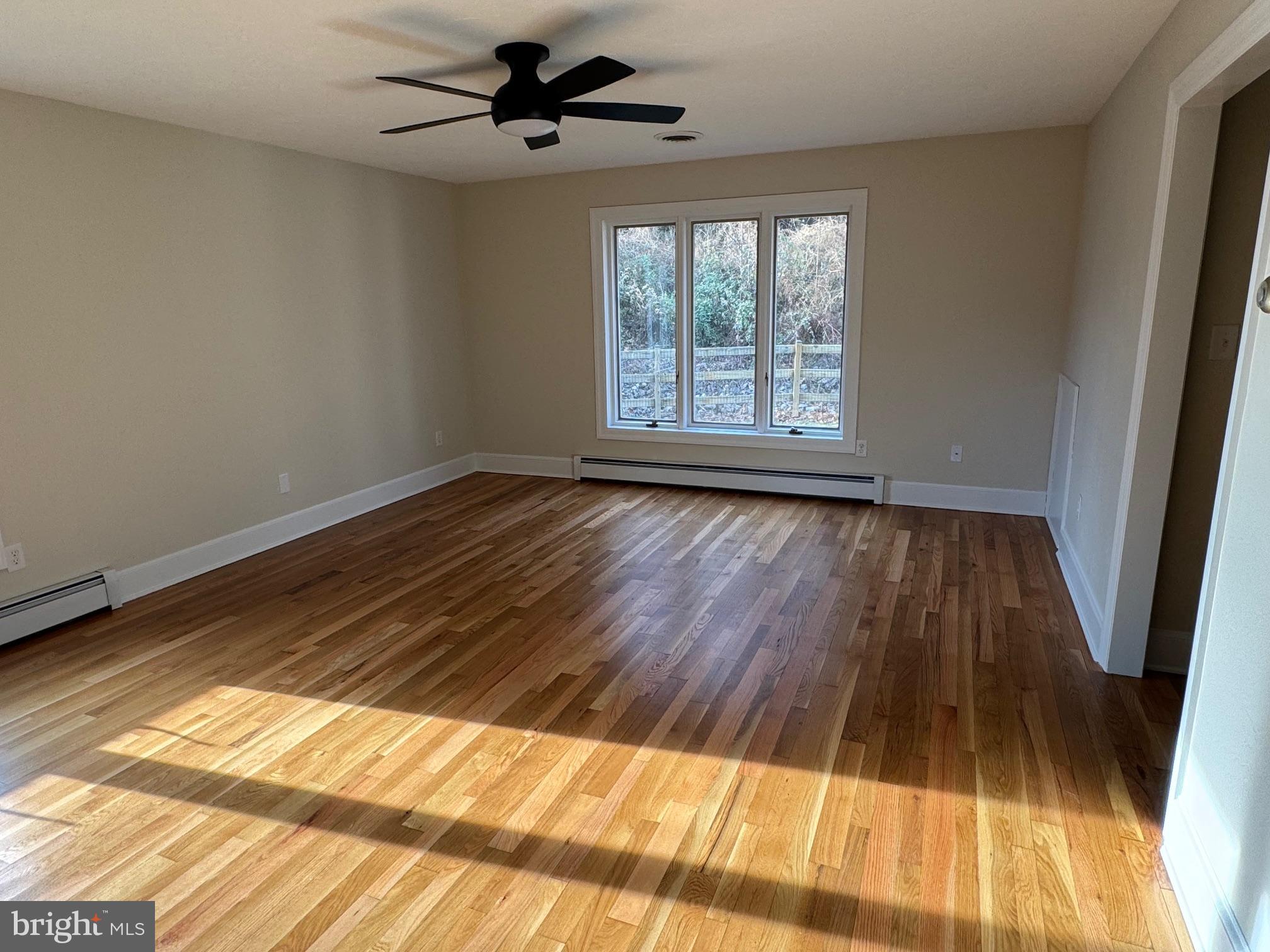 210 Raintree Lane Fairfield, PA 17320 - Photo 9 of 23 a view of empty room with wooden floor and fan