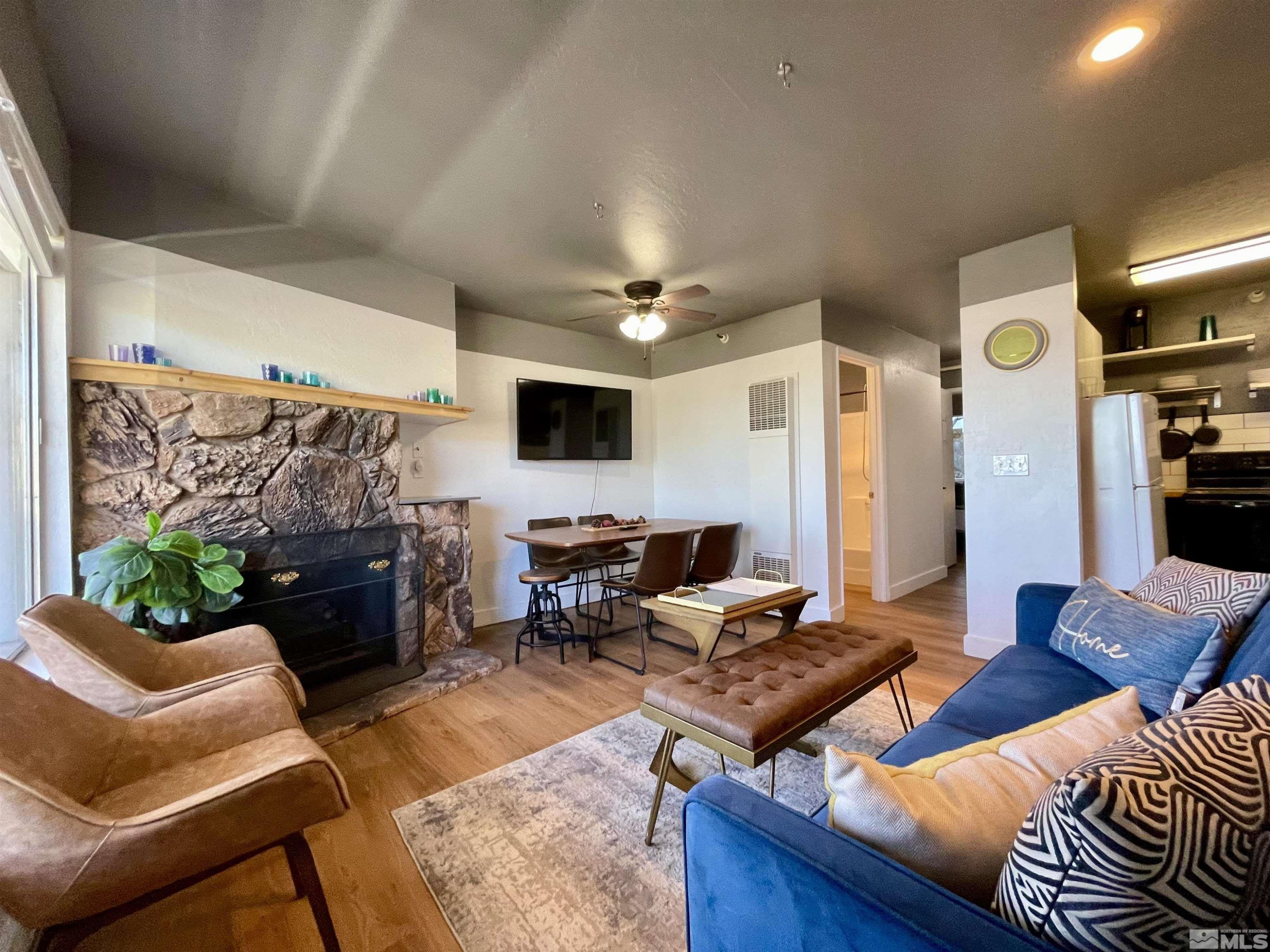 261 Quaking Aspen Lane, Unit B Stateline, NV 89449 - Photo 1 of 40 a living room with furniture and a flat screen tv