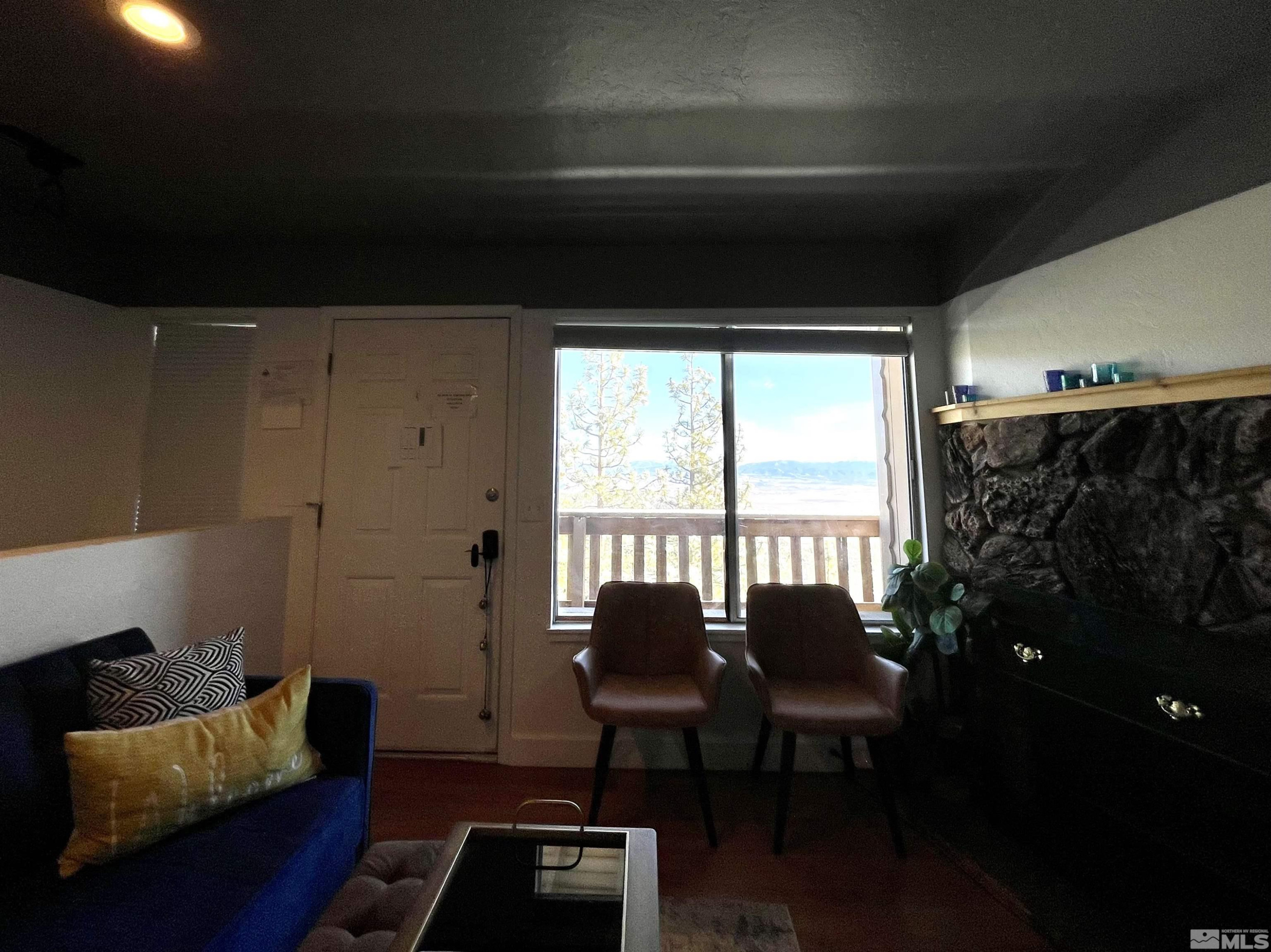 261 Quaking Aspen Lane, Unit B Stateline, NV 89449 - Photo 11 of 40 a living room with furniture and a window
