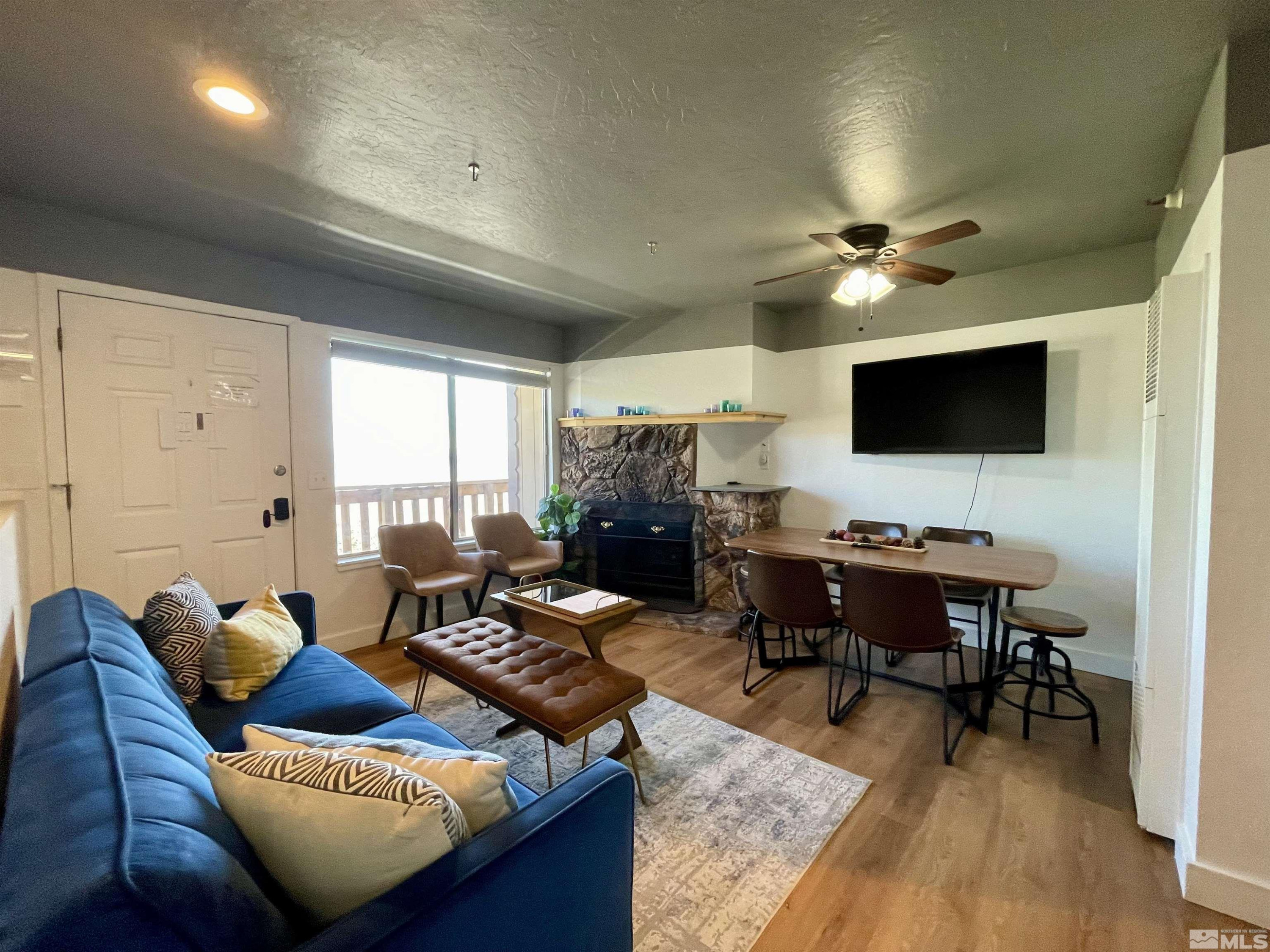 261 Quaking Aspen Lane, Unit B Stateline, NV 89449 - Photo 12 of 40 a living room with furniture ceiling fan and a rug