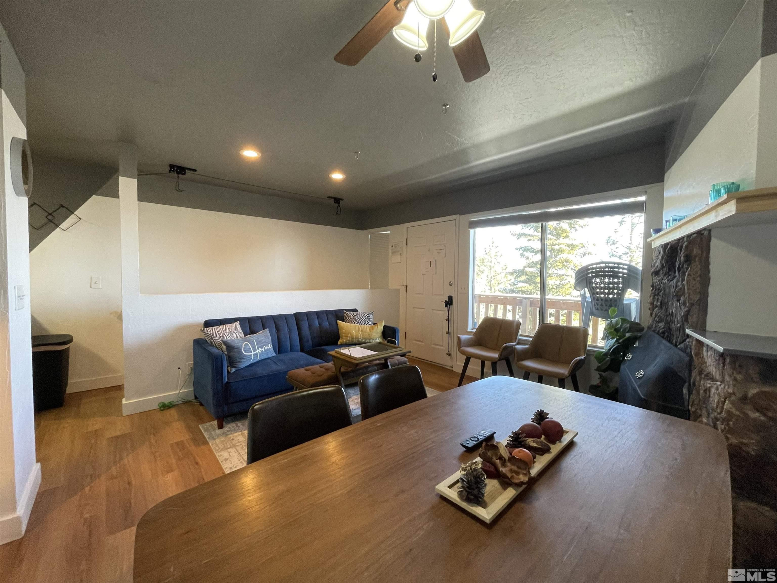 261 Quaking Aspen Lane, Unit B Stateline, NV 89449 - Photo 13 of 40 a living room with furniture flat screen tv and a large window