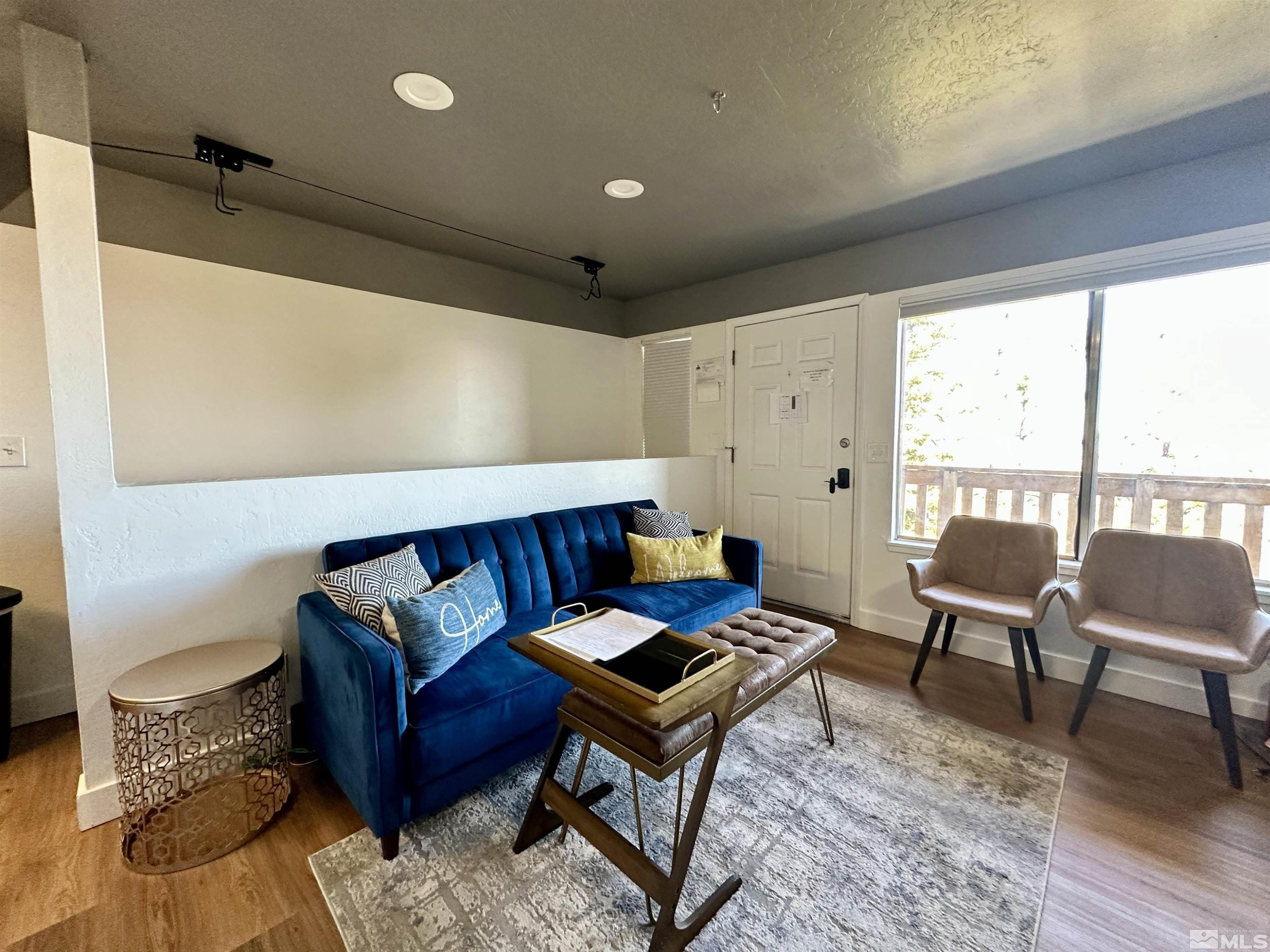 261 Quaking Aspen Lane, Unit B Stateline, NV 89449 - Photo 14 of 40 a living room with furniture and a wooden floor