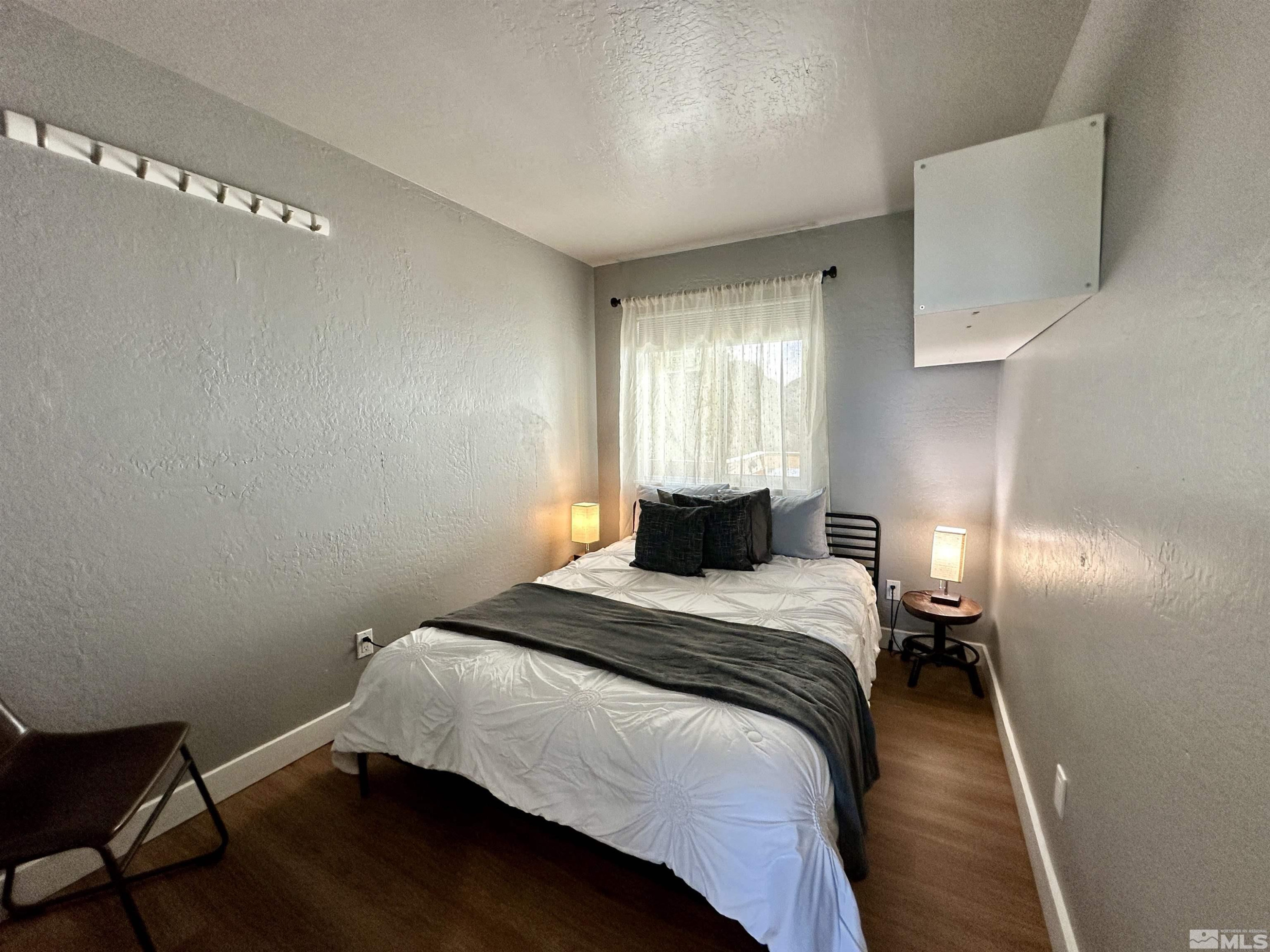 261 Quaking Aspen Lane, Unit B Stateline, NV 89449 - Photo 15 of 40 a bedroom with a bed and a window