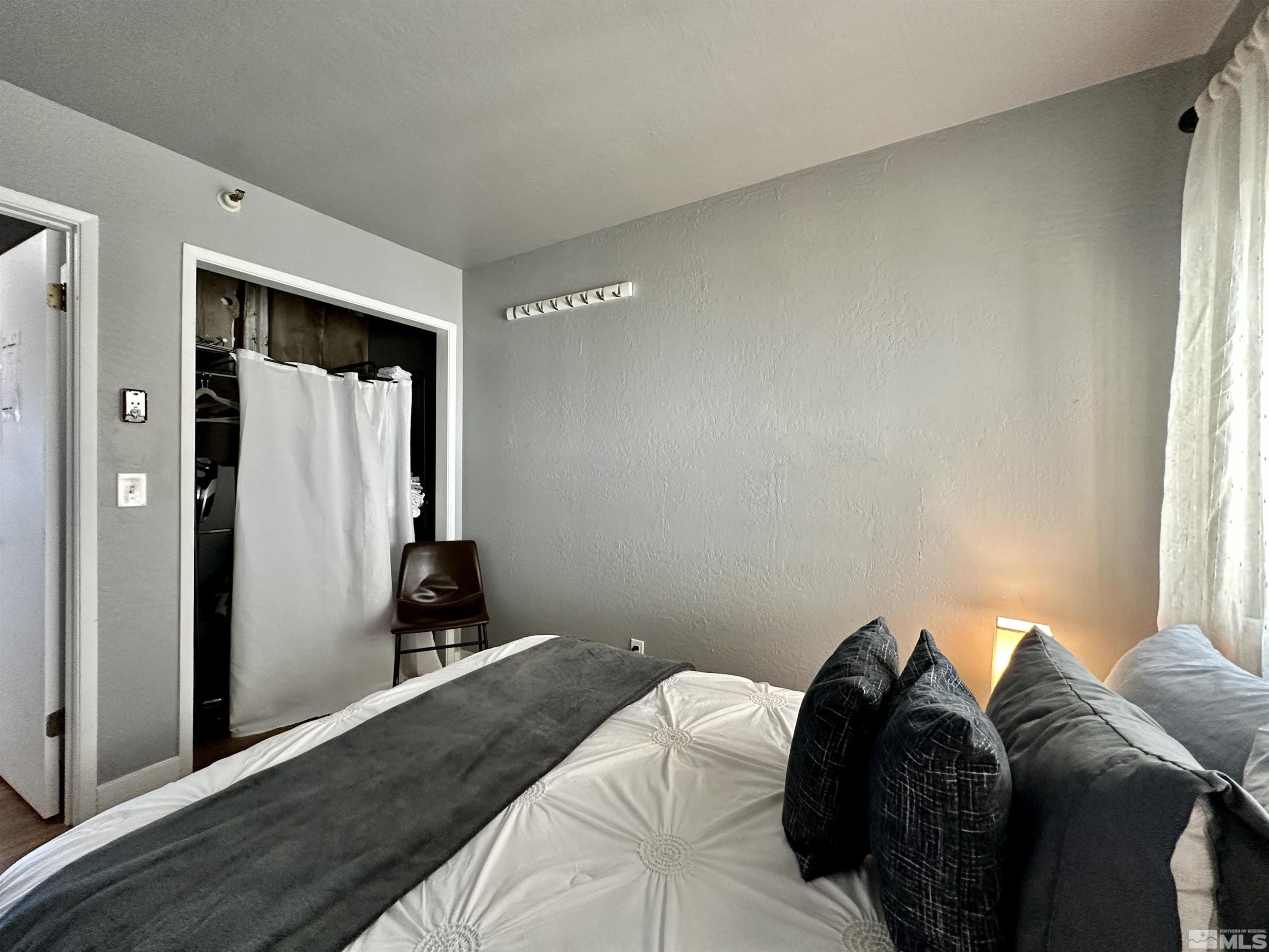 261 Quaking Aspen Lane, Unit B Stateline, NV 89449 - Photo 17 of 40 a bed sitting in a bedroom next to a window