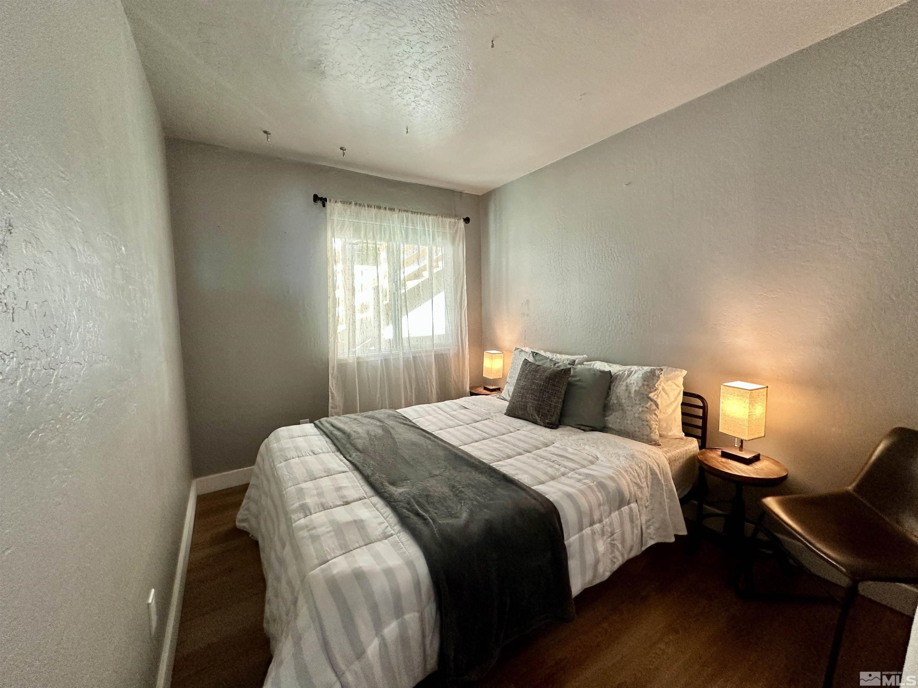 261 Quaking Aspen Lane, Unit B Stateline, NV 89449 - Photo 18 of 40 a bedroom with a bed and a window