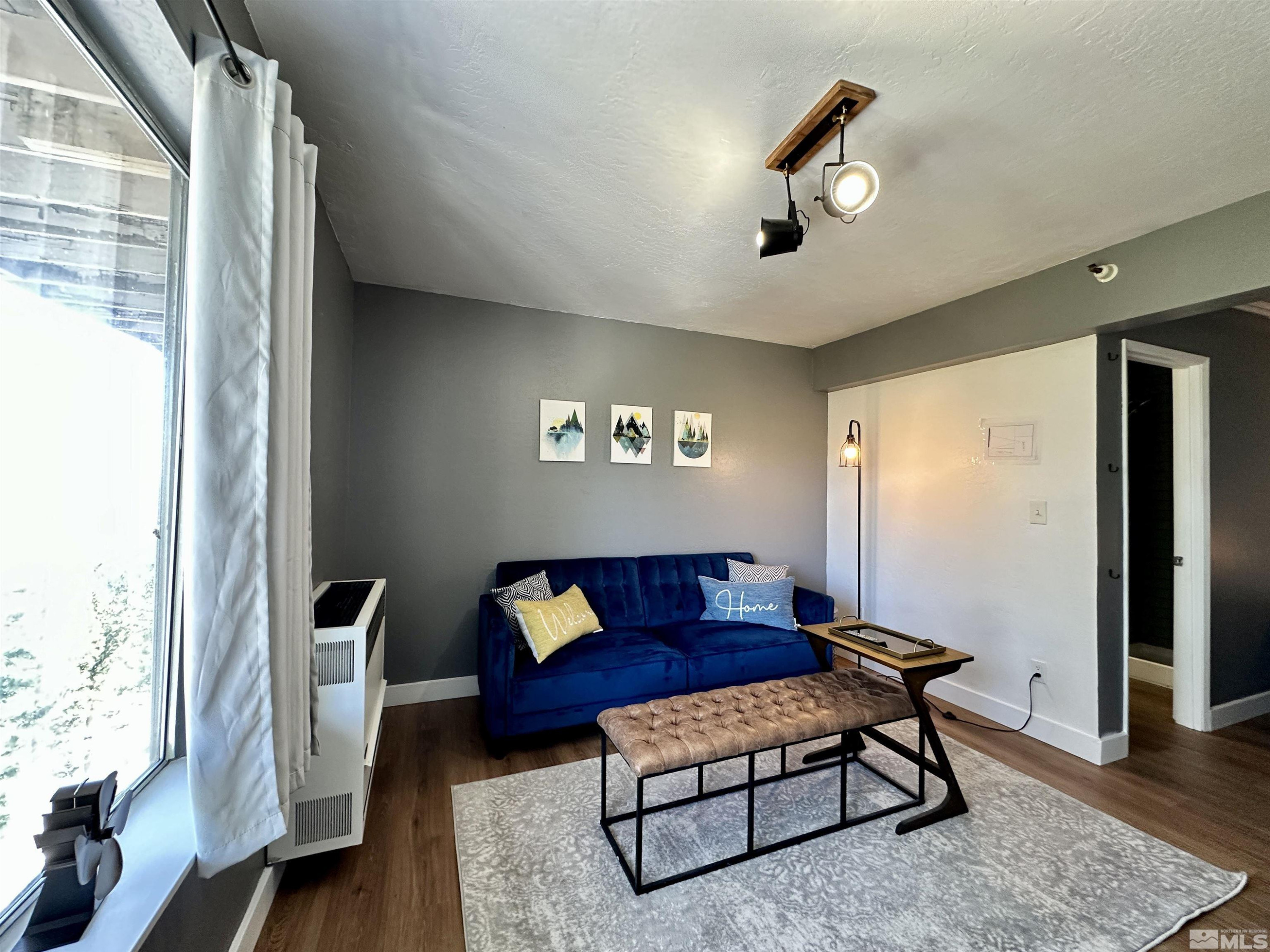 261 Quaking Aspen Lane, Unit B Stateline, NV 89449 - Photo 24 of 40 a living room with furniture and a large window