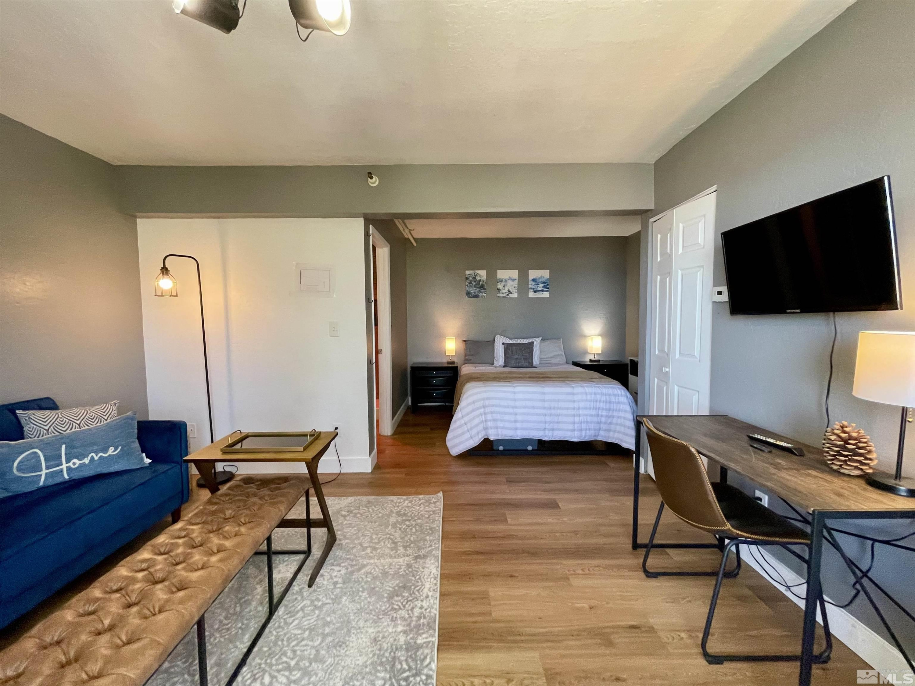 261 Quaking Aspen Lane, Unit B Stateline, NV 89449 - Photo 25 of 40 a bedroom with furniture and a flat screen tv