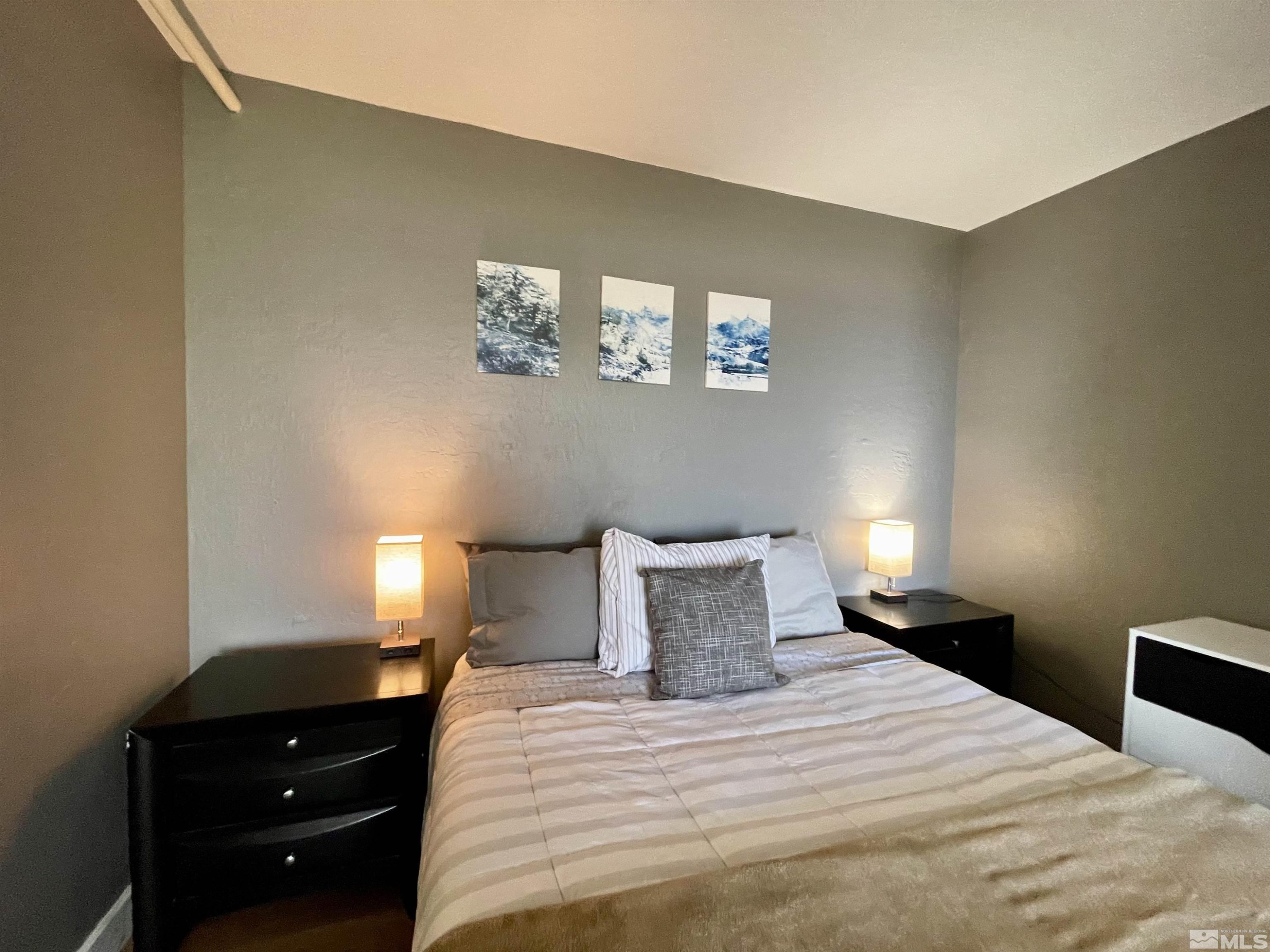 261 Quaking Aspen Lane, Unit B Stateline, NV 89449 - Photo 28 of 40 a bedroom with a bed and a window