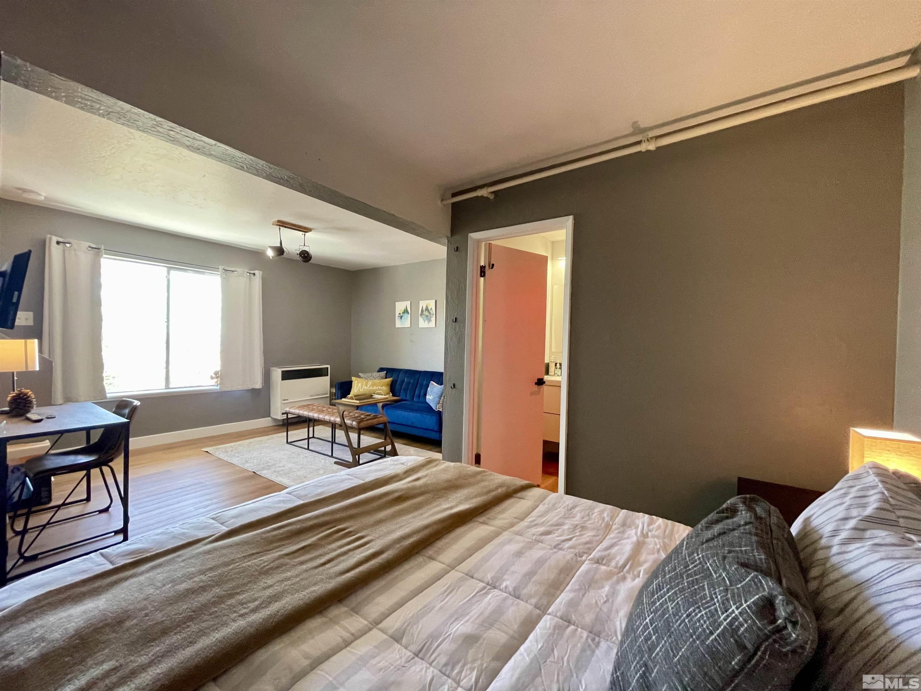 261 Quaking Aspen Lane, Unit B Stateline, NV 89449 - Photo 29 of 40 a bedroom with a bed and a table in it