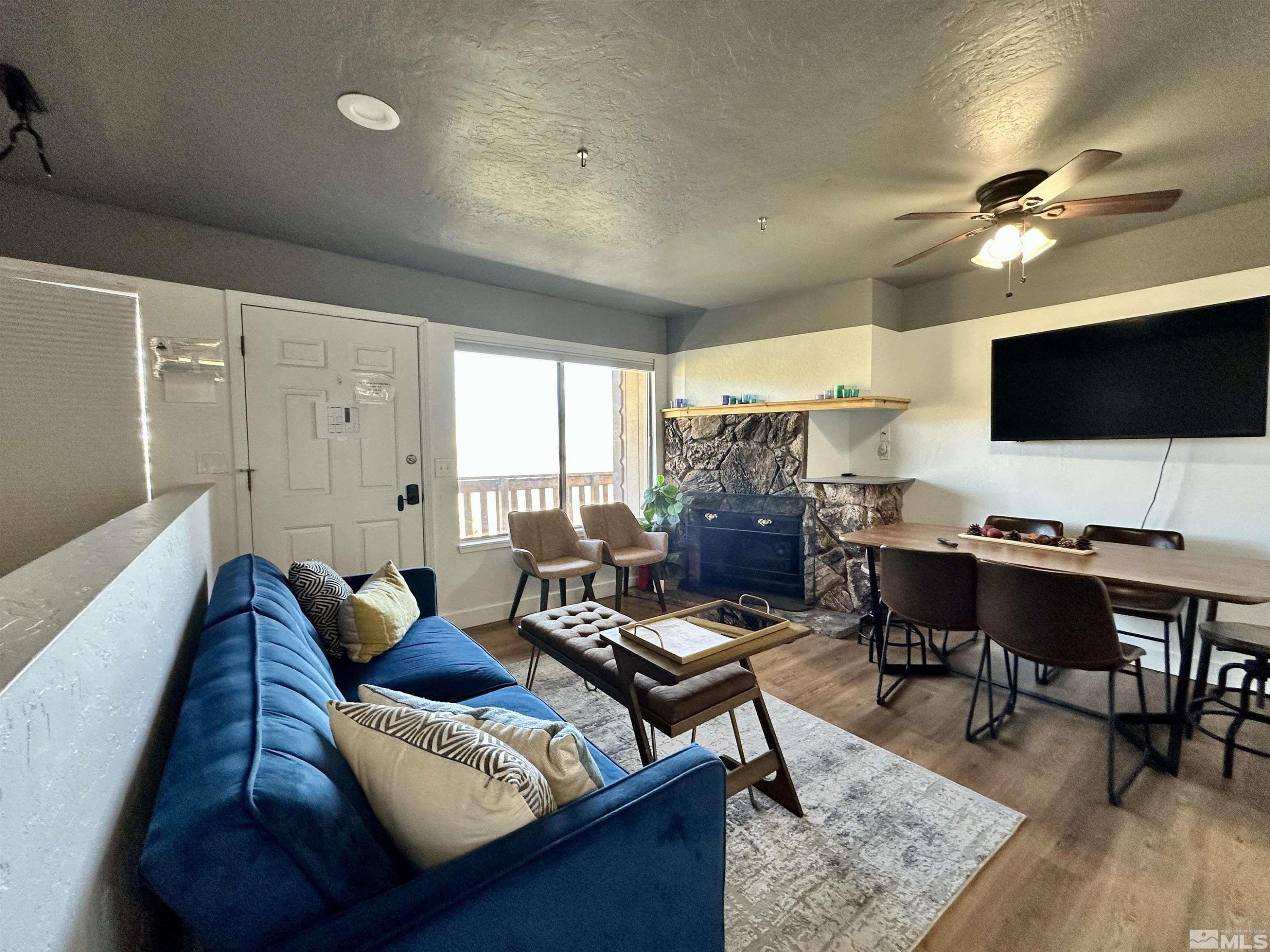 261 Quaking Aspen Lane, Unit B Stateline, NV 89449 - Photo 3 of 40 a living room with furniture and a flat screen tv
