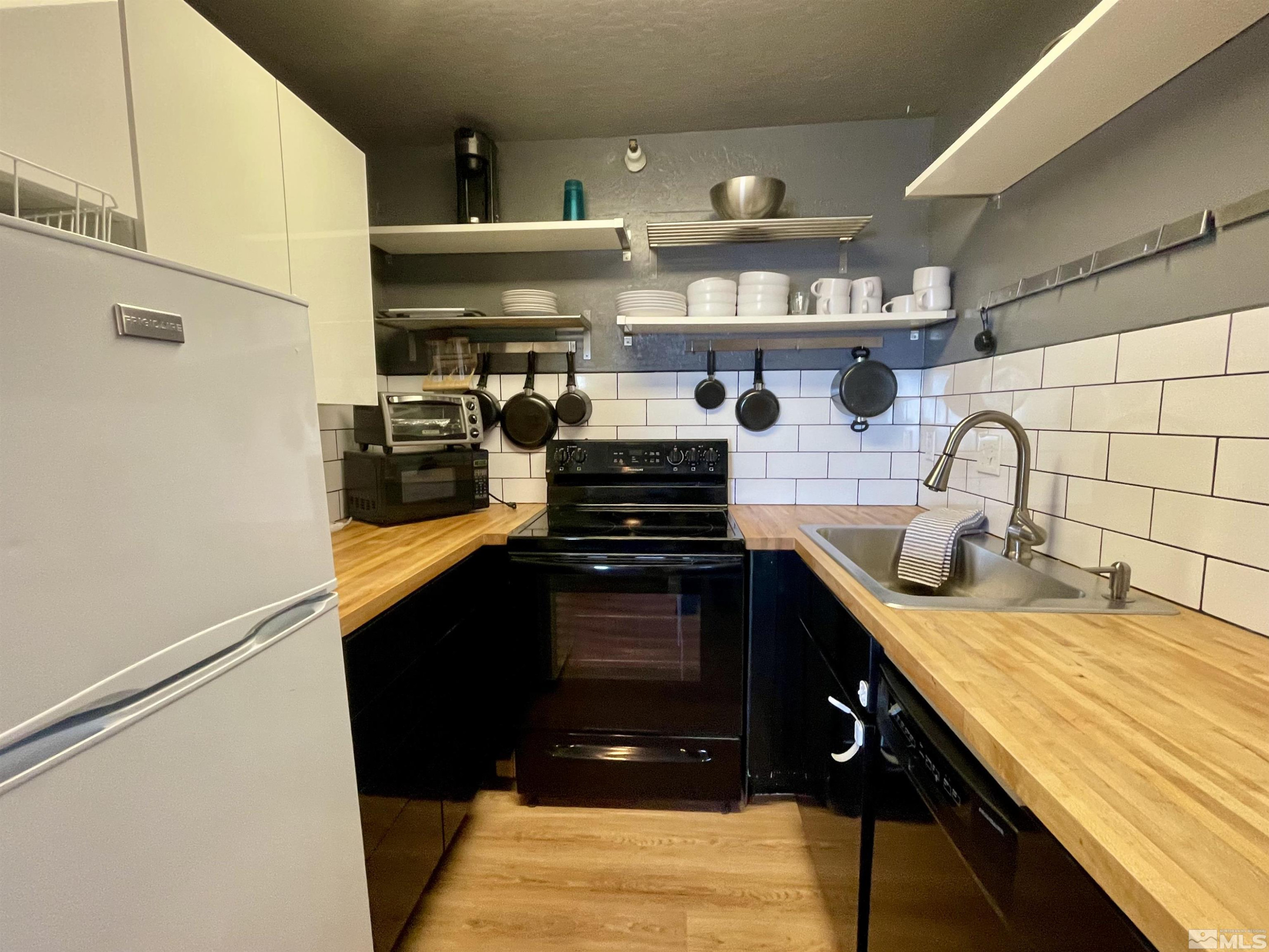 261 Quaking Aspen Lane, Unit B Stateline, NV 89449 - Photo 32 of 40 a kitchen with a stove and a sink