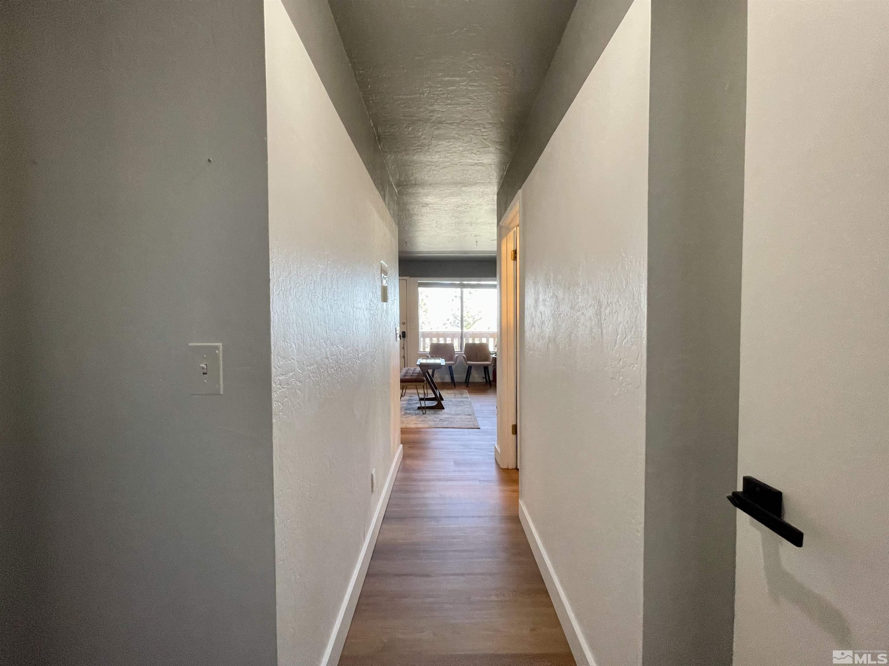 261 Quaking Aspen Lane, Unit B Stateline, NV 89449 - Photo 33 of 40 a view of a hallway with wooden floor and staircase