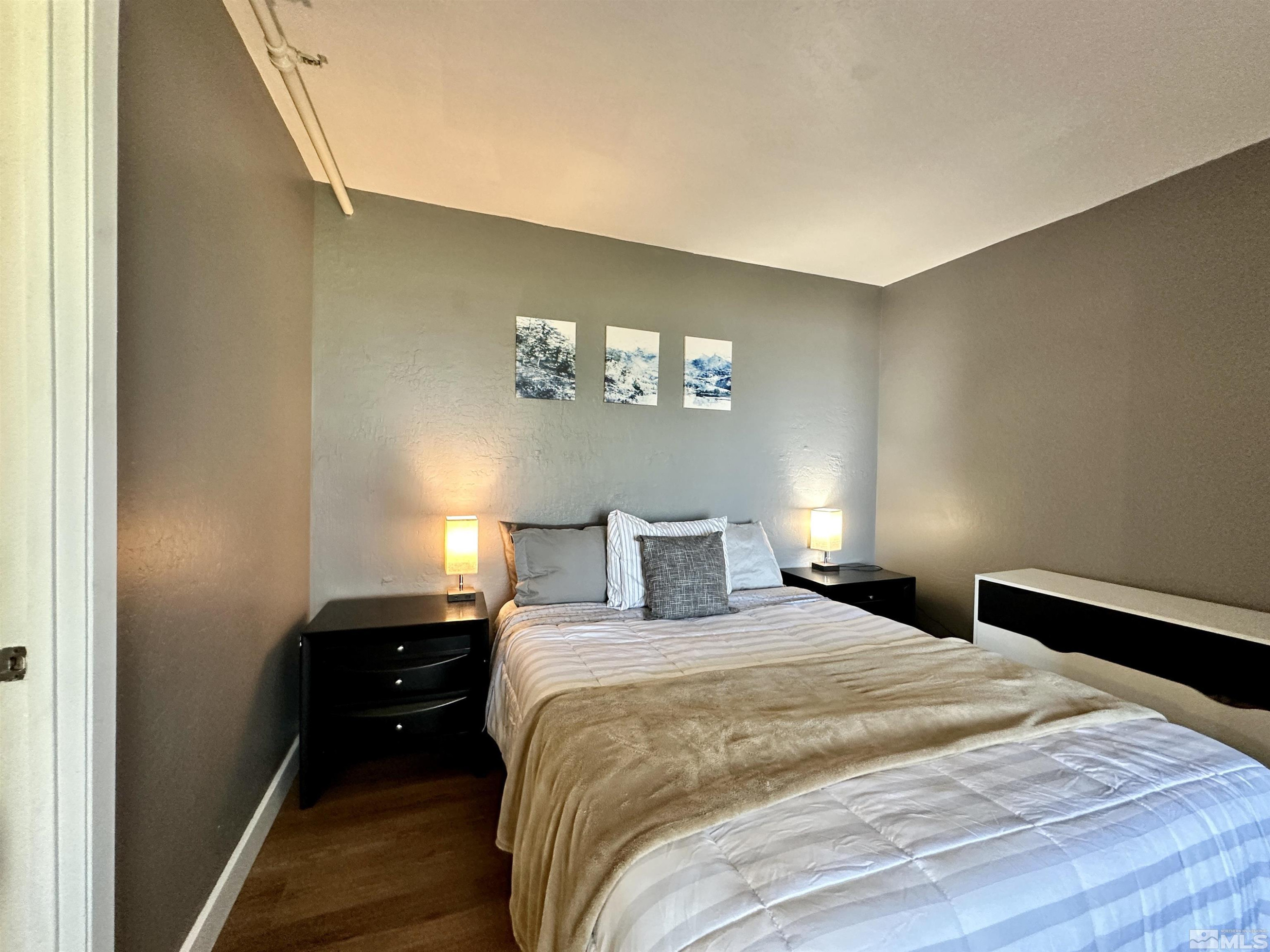 261 Quaking Aspen Lane, Unit B Stateline, NV 89449 - Photo 36 of 40 a bedroom with a bed and a lamp on the dresser