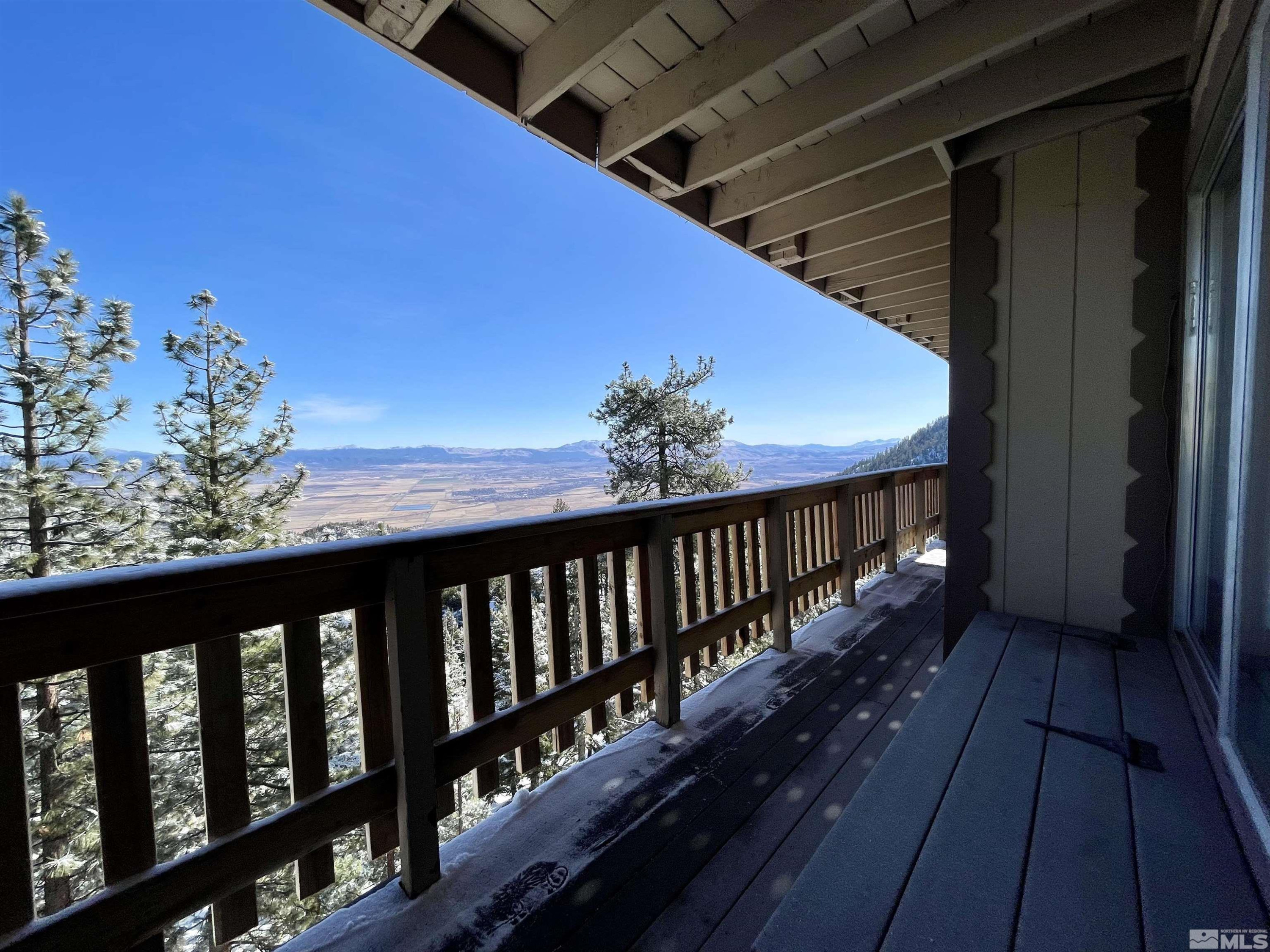 261 Quaking Aspen Lane, Unit B Stateline, NV 89449 - Photo 37 of 40 a balcony with wooden floor and fence
