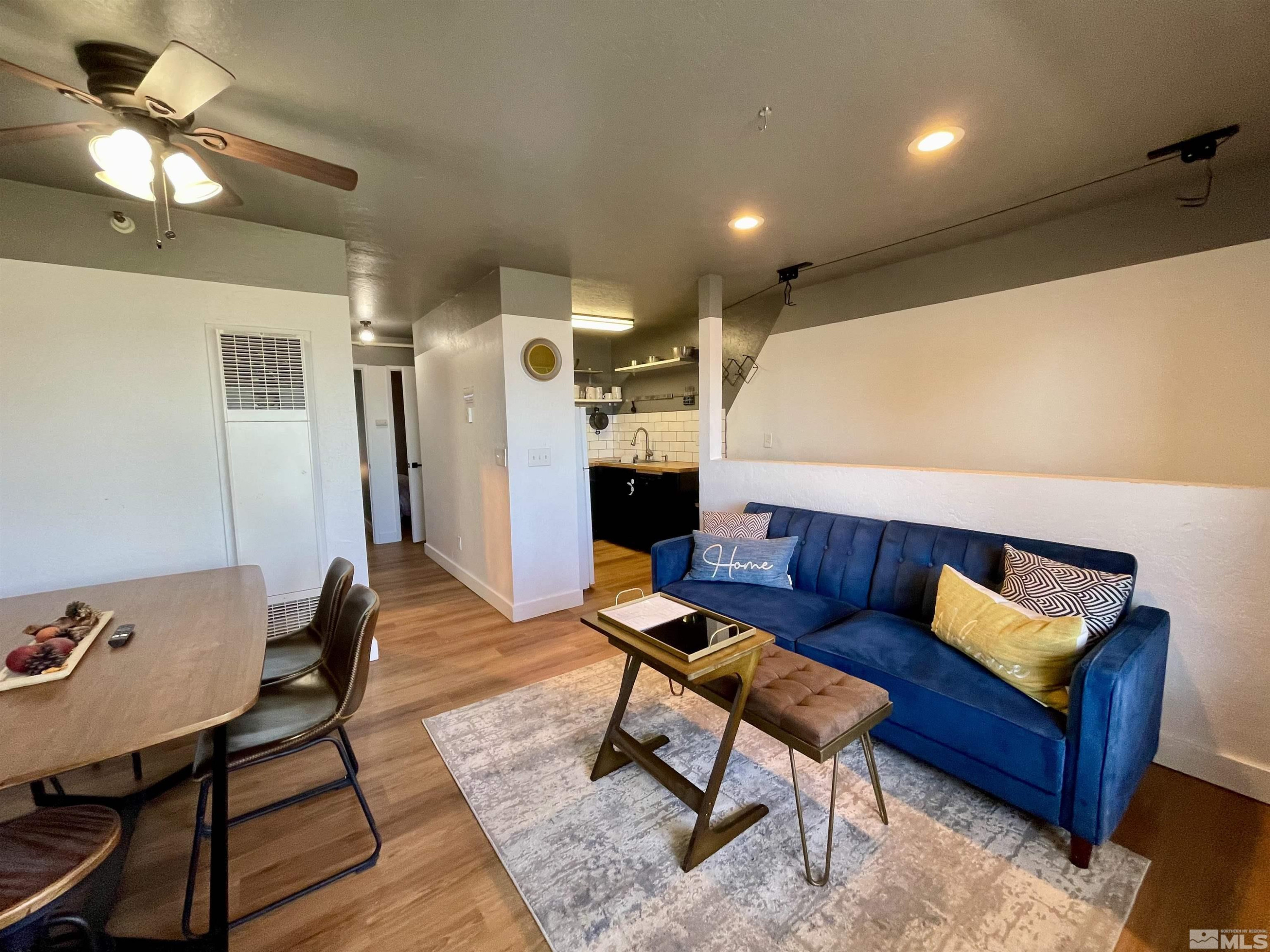 261 Quaking Aspen Lane, Unit B Stateline, NV 89449 - Photo 5 of 40 a living room with furniture and a chandelier