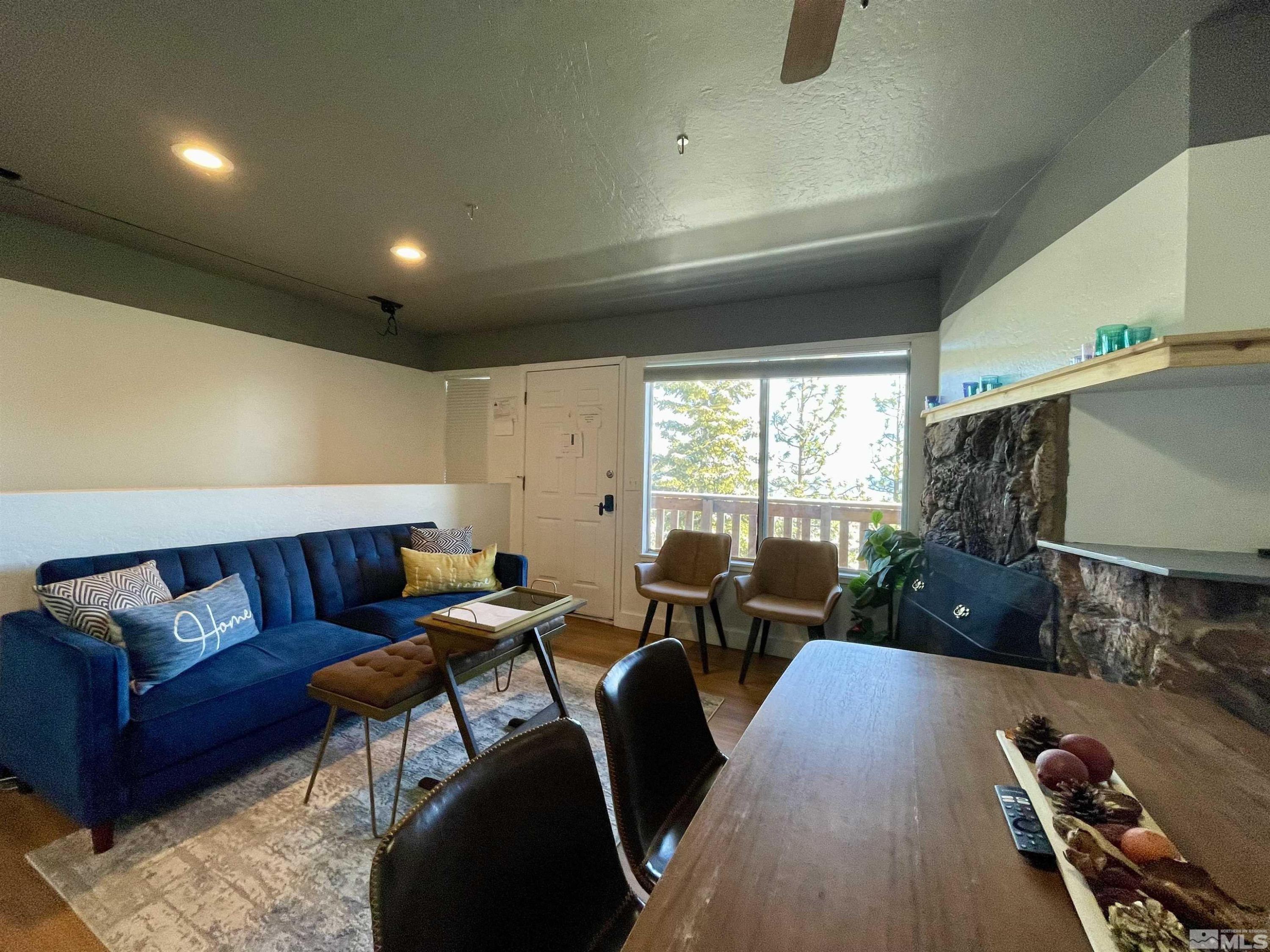 261 Quaking Aspen Lane, Unit B Stateline, NV 89449 - Photo 6 of 40 a living room with furniture and a flat screen tv