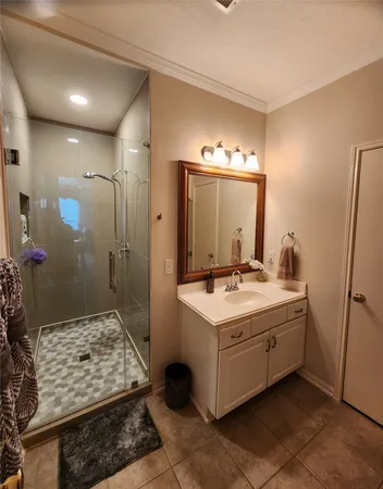 a bathroom with a sink a mirror and a shower