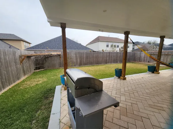 a view of a back yard with a patio
