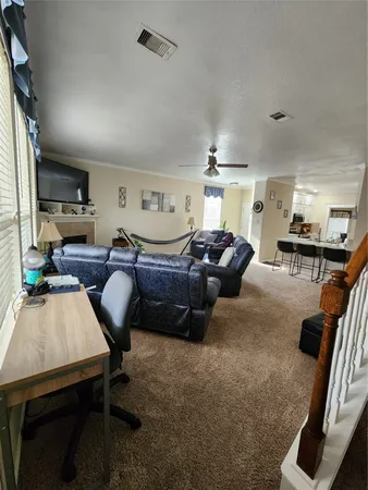 a living room with furniture a wooden floor and a large window