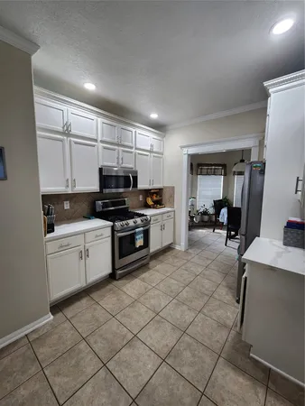 a kitchen with cabinets a sink and white appliances