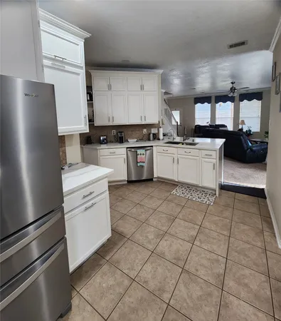 a kitchen with a refrigerator and a sink