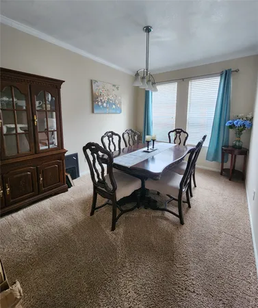 a dining room with furniture and window