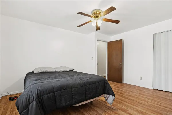 a bedroom with a bed and a chandelier