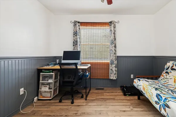 a workspace with furniture and wooden floor