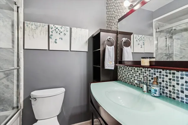 a bathroom with a sink toilet and mirror