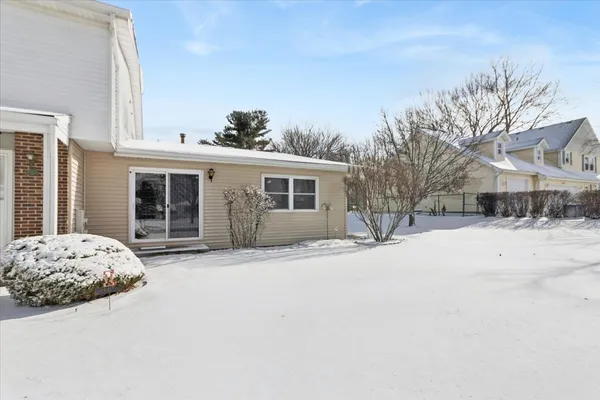 a front view of a house with a snow covered in snow
