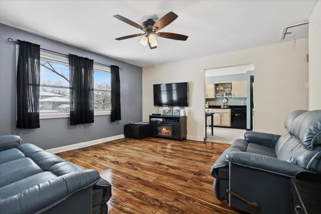 a living room with furniture flat screen tv and window