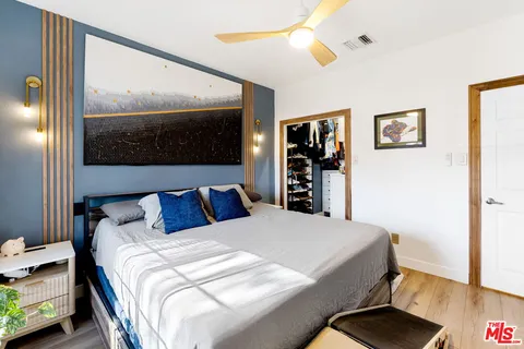 a bedroom with a large bed and a flat screen tv