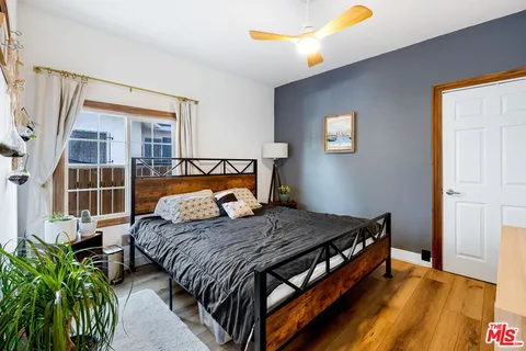 a bed sitting in a bedroom next to a window