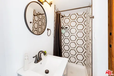 a bathroom with a sink and a mirror