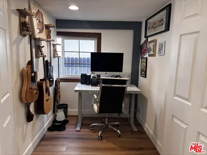 a view of a workspace with furniture and a window