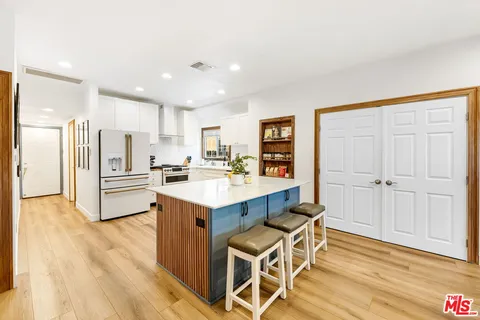 a kitchen with a sink cabinets and wooden floor