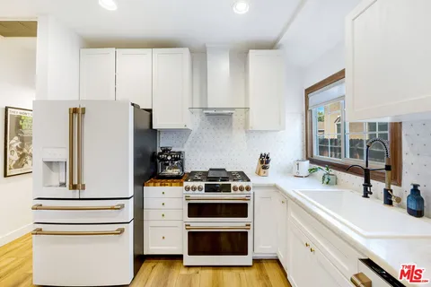 a kitchen with a white stove top oven and refrigerator