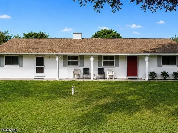 a front view of house with yard and green space