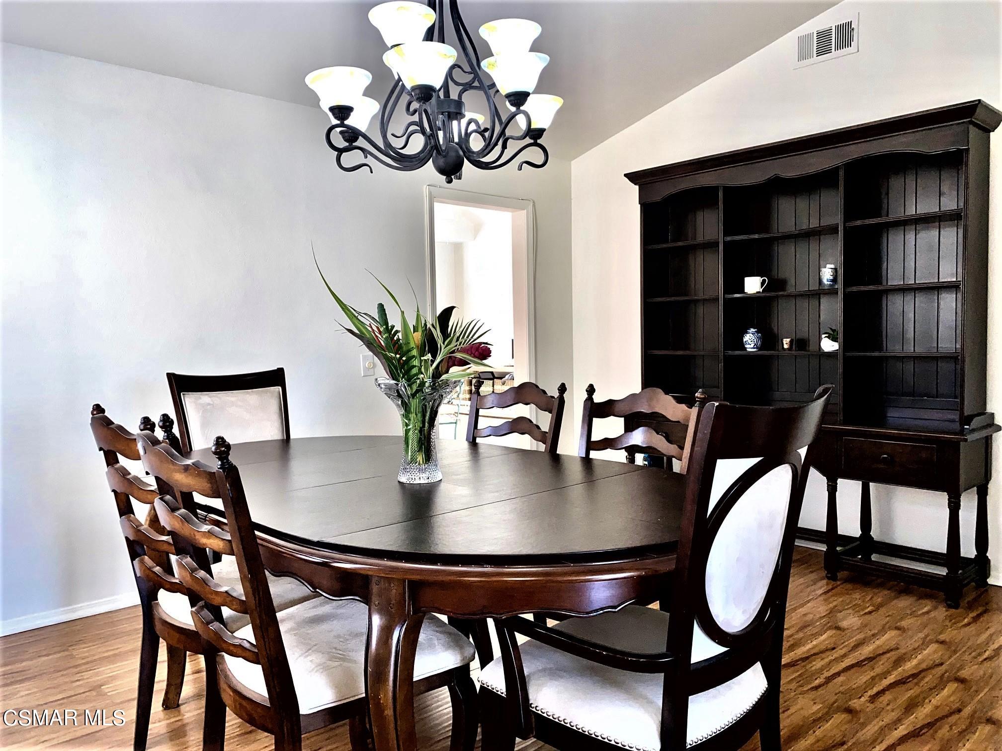 a view of a dining room with furniture and chandelier