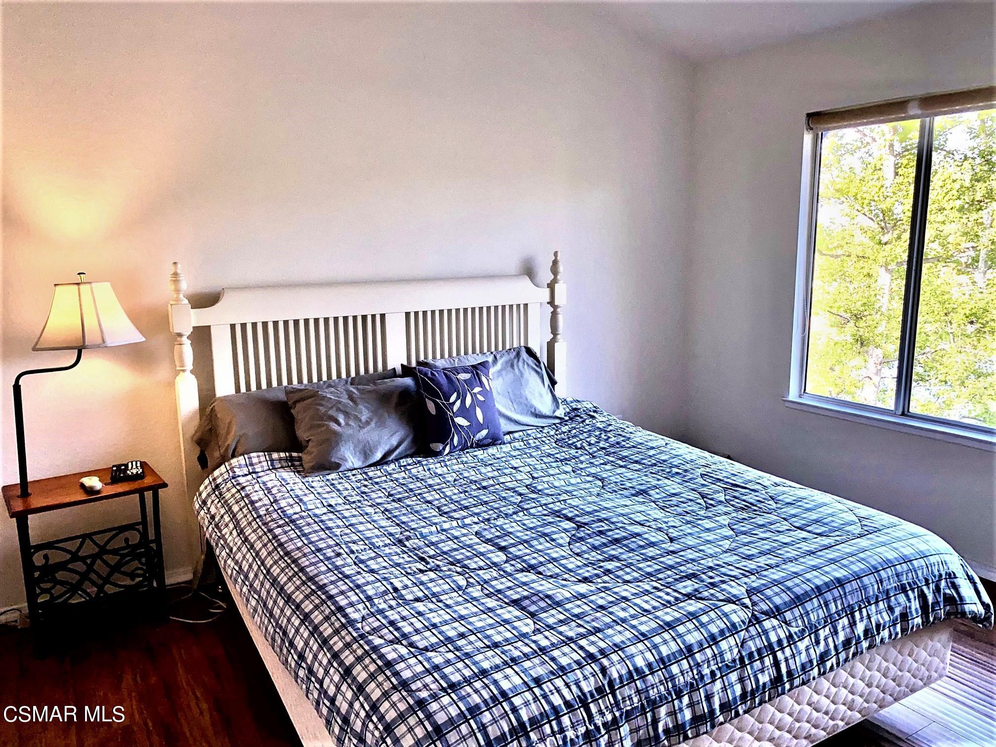 290 Ridgeton Lane, Unit B Simi Valley, CA 93065 - Photo 16 of 25 a bedroom with a bed and a window