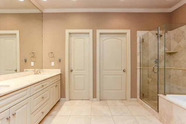 a spacious bathroom with a shower sink and mirror