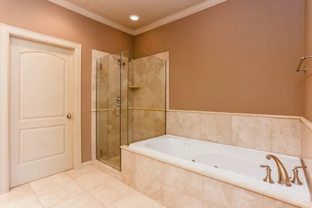 a bathroom with a bathtub and a shower