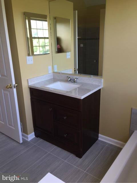 27 Bank Spring Court Owings Mills, MD 21117 - Photo 20 of 27 a bathroom with a sink and a mirror