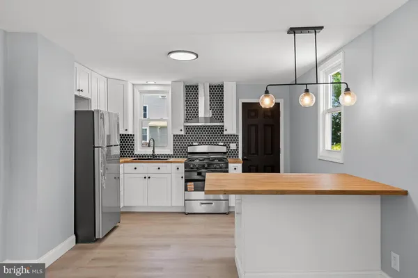 a kitchen with stainless steel appliances a refrigerator sink and stove