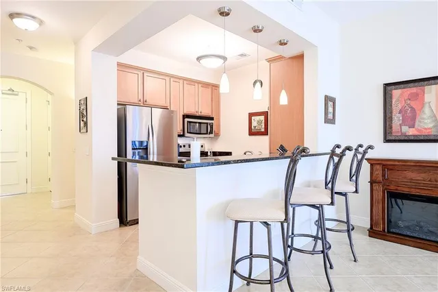a kitchen with granite countertop a refrigerator and a sink