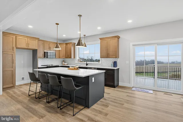a kitchen with stainless steel appliances granite countertop a sink a stove and a refrigerator