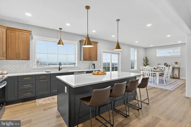 a kitchen with center island table and chairs