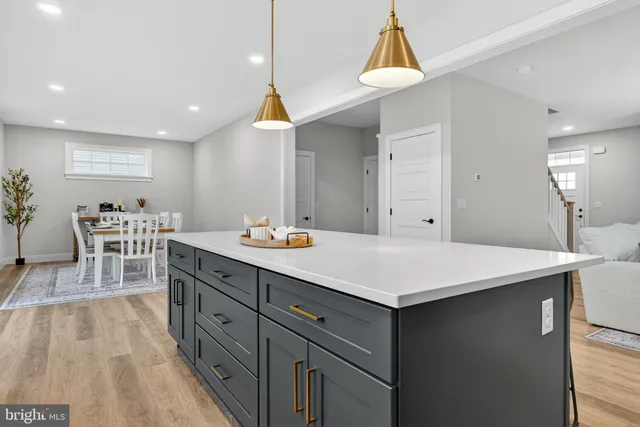 a kitchen with a sink cabinets and wooden floor