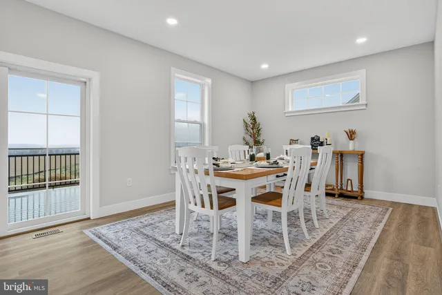 a dining room with furniture wooden floor and a rug
