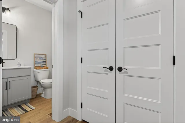 a view of a hallway view with wooden floor and staircase
